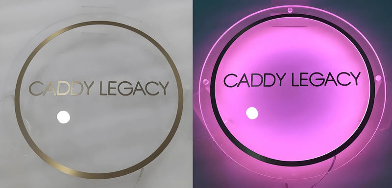 Minimalist custom acrylic backlit sign for Caddy Legacy brand, featuring pink LED glow and elegant gold lettering contrast between lit and unlit modes.
