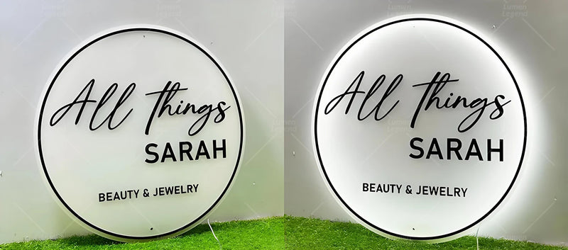 Sleek acrylic backlit sign crafted for a beauty and jewelry boutique, featuring elegant black lettering and a soft white LED glow that adds a refined, modern touch to the shop’s interior or storefront.