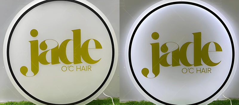 Modern round acrylic backlit sign with elegant gold lettering on a white background, softly glowing from behind. The design exudes a clean, upscale look ideal for hair salons or beauty studios, showcasing stylish branding with warm ambient lighting.